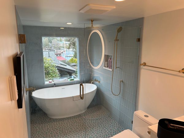 Bathroom remodel with freestanding tub, tiled walk-in shower and glass partition