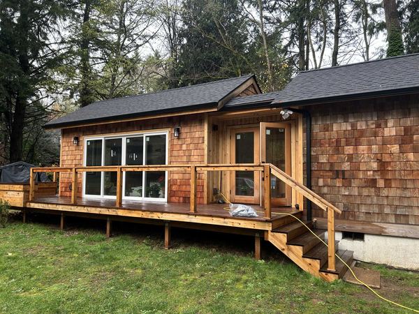 Cabin with cedar shingle siding and deck